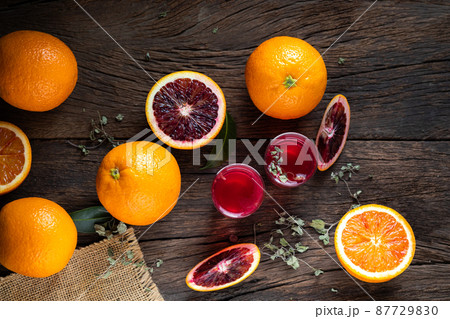 Sliced Sicilian Blood oranges fruits over old dark wooden background. Top view. Sliced Sicilian Blood oranges fruits over old dark wooden background. Top view. 87729830