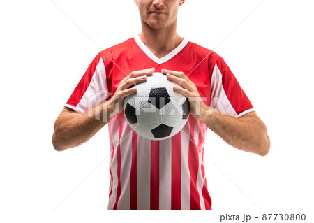 Midsection of young male caucasian soccer athlete holding ball standing against white background Midsection of young male caucasian soccer athlete holding ball standing against white background 87730800