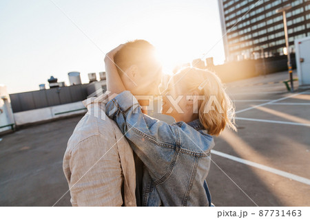happy young couple on roof top city parking 87731463