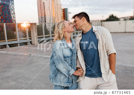 happy young couple on roof top city parking 87731465