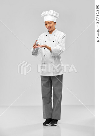 female chef applying hand sanitizer or liquid soap female chef applying hand sanitizer or liquid soap 87731890