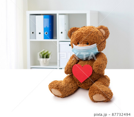 teddy bear in mask with red heart at clinic teddy bear in mask with red heart at clinic 87732494