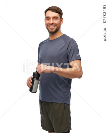 smiling man in sports clothes with bottle 87732495