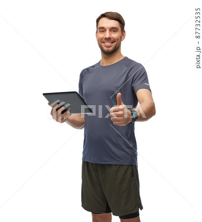 smiling man holding tablet pc showing thumbs up smiling man holding tablet pc showing thumbs up 87732535