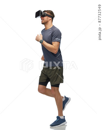 happy man in vr glasses running and training 87732549