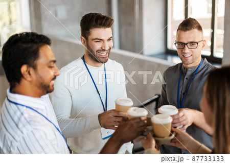 business people drinking takeaway coffee at office 87733133