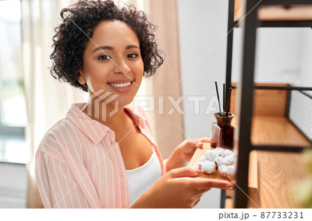 woman with aroma reed diffuser and cotton at home woman with aroma reed diffuser and cotton at home 87733231