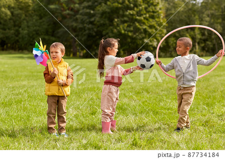 happy kids with pinwheel having fun at park 87734184