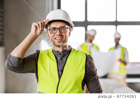 male architect in helmet and safety west at office male architect in helmet and safety west at office 87734261