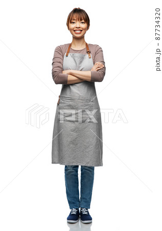 smiling woman in apron with crossed arms 87734320