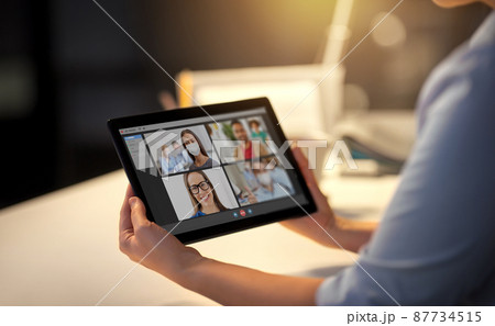 woman with video call on tablet pc at office woman with video call on tablet pc at office 87734515
