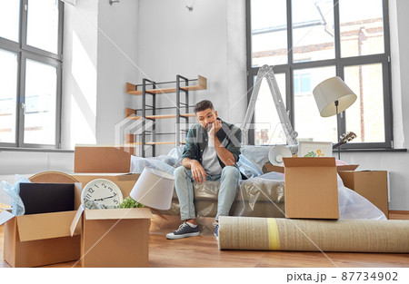 sad man with boxes moving to new home 87734902