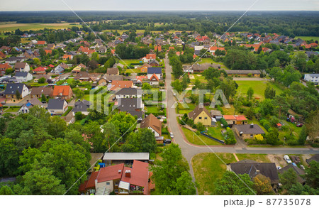 Suburb in Germany with houses arranged in rows for families with close neighborhood and small gardens Suburb in Germany with houses arranged in rows for families with close neighborhood and small gardens 87735078