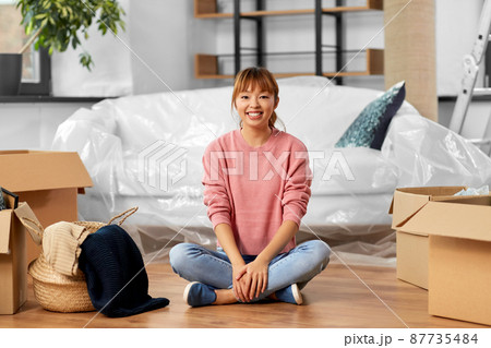 happy woman with boxes moving to new home 87735484