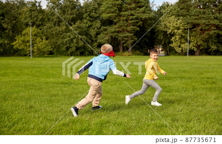 happy boys playing and running at park 87735671