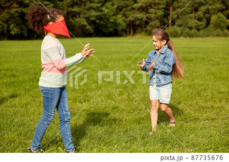 happy girls playing and running at park 87735676