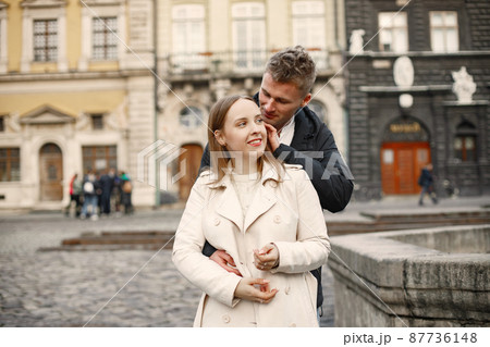 Romantic couple hugging and kissing in the street of old town Romantic couple hugging and kissing in the street of old town 87736148