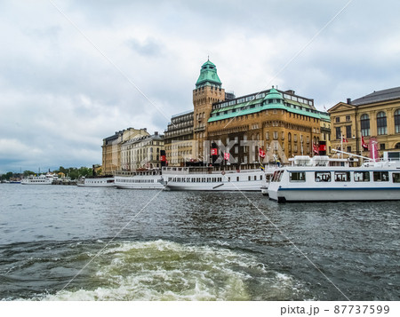 Panoramic view from the tourist excursion boat to the pier with boats and the beautiful buildings of Stockholm Sweden 87737599