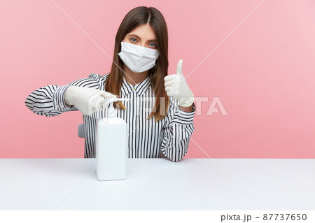 Excellent hygiene, preventive measures during quarantine. Woman employee washing hands with antiseptic gel and showing thumbs up, using disinfection at workplace, home office while covid-19 epidemic 87737650