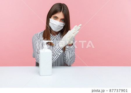 Be aware of hygiene, preventive measures during coronavirus quarantine. Woman employee washing hands with antiseptic gel, using disinfection at workplace, home office while covid-19 epidemic. indoor Be aware of hygiene, preventive measures during coronavirus quarantine. Woman employee washing hands with antiseptic gel, using disinfection at workplace, home office while covid-19 epidemic. indoor 87737901