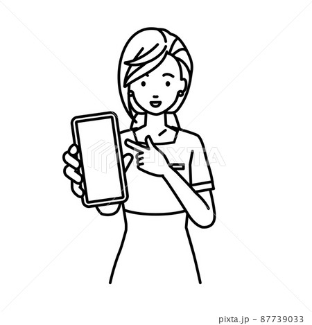 立ってスマートフォンを指差してこちらに向けて見せているエステ店員・受付・接客係の女性 87739033