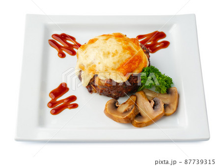 Meat with melting slice of cheese isolated on white background. 87739315