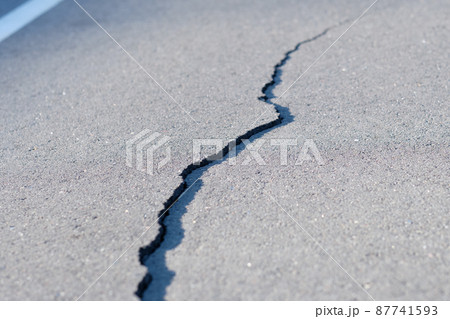 Cracked road surface requiring immediate repair of asphalt concrete pavement 87741593
