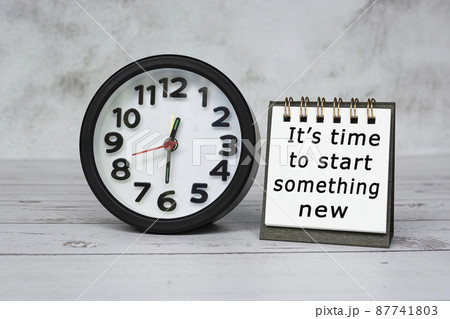 Motivation text on notepad with black alarm clock set time at 12.30 on desk. 87741803