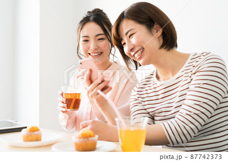 二人でスマホを見る女性 二人でスマホを見る女性 87742373