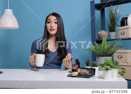 Portrait of social media influencer filming beauty podcast Portrait of social media influencer filming beauty podcast 87742386