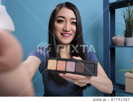 Pov of asian influencer holding makeup palette showing to fans Pov of asian influencer holding makeup palette showing to fans 87742387