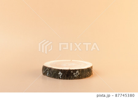 Wooden tray podium for cosmetics. Front view. Luxury and natural autumn cosmetics presentation. Woodcut for perfume. Front view 87745380