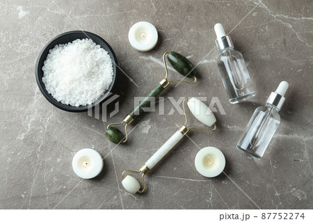 Skin care concept with face rollers on gray textured table Skin care concept with face rollers on gray textured table 87752274