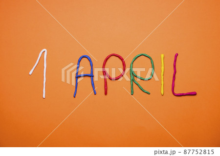 Funny font first april fools day written in plastecine of different colors. 87752815