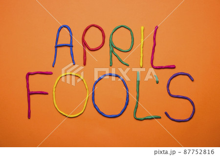 Funny font first april fools day written in plastecine of different colors. 87752816
