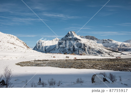 Snowy mountain range on coastline in winter on sunny day at Lofoten islands Snowy mountain range on coastline in winter on sunny day at Lofoten islands 87755917
