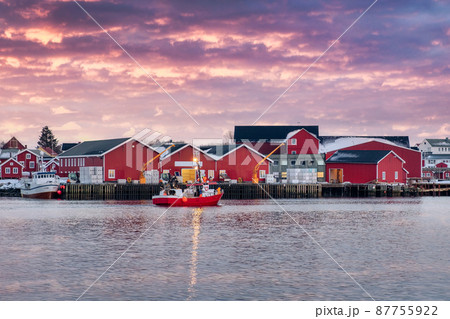 Beautiful rorbuer fishing village and fishing boat on coastline in the sunset at Reine town, Lofoten islands Beautiful rorbuer fishing village and fishing boat on coastline in the sunset at Reine town, Lofoten islands 87755922