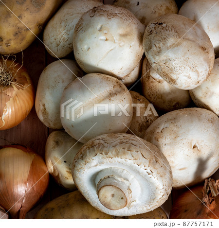 Fresh vegetables and mushrooms lie on the table against the background of a brick wall Fresh vegetables and mushrooms lie on the table against the background of a brick wall 87757171