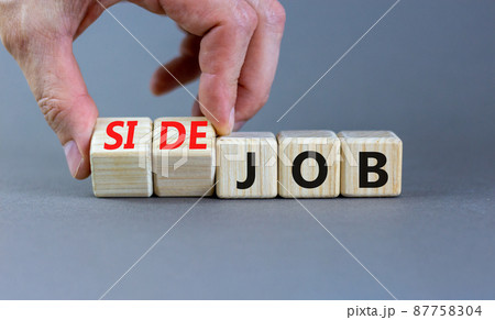 Side job symbol. Businessman turns wooden cubes and changes concept words Job to Side job. Beautiful grey table grey background, copy space. Business side job concept. 87758304