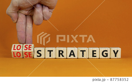 Lose-lose strategy symbol. Businessman turns wooden cubes with words lose lose strategy. Beautiful orange table, orange background. Business, lose-lose strategy concept. Copy space. Lose-lose strategy symbol. Businessman turns wooden cubes with words lose lose strategy. Beautiful orange table, orange background. Business, lose-lose strategy concept. Copy space. 87758352