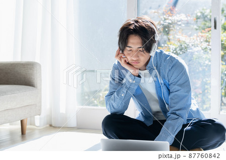 音楽を聞く若い男性 音楽を聞く若い男性 87760842