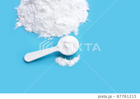 Baking soda on blue background. Baking soda on blue background. 87761215