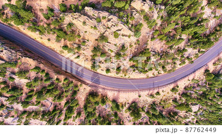 Aerial road through desert landscape looking down 87762449