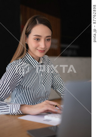 Business woman using laptop computer at office, account or saving money or insurance concept. 87762898