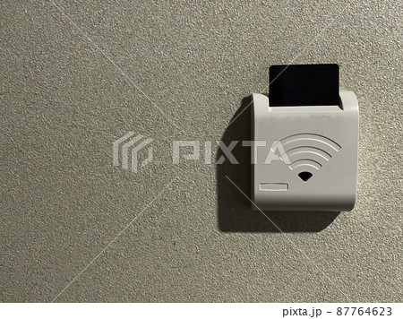 close up put hotel key card in bedroom for electricity 87764623