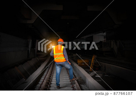 Engineer under discussion inspection and checking construction process railway switch and checking work on railroad station .Engineer wearing safety uniform and safety helmet in work. Engineer under discussion inspection and checking construction process railway switch and checking work on railroad station .Engineer wearing safety uniform and safety helmet in work. 87766107