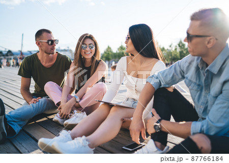 Men and women spending free time together in park 87766184