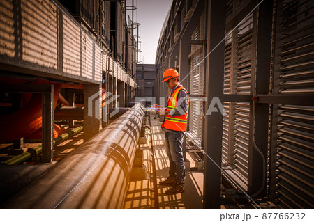 Industry engineer under checking the industry cooling tower air conditioner is water cooling tower air chiller HVAC of large industrial building to control air system Industry engineer under checking the industry cooling tower air conditioner is water cooling tower air chiller HVAC of large industrial building to control air system 87766232
