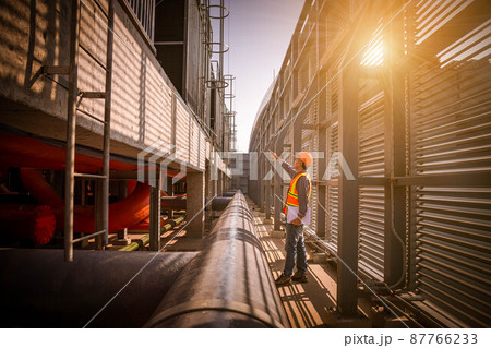 Industry engineer under checking the industry cooling tower air conditioner is water cooling tower air chiller HVAC of large industrial building to control air system 87766233