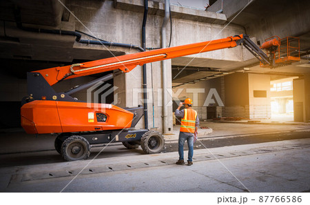 Engineer under discussion inspection and checking construction process railway switch and checking work on railroad station .Engineer wearing safety uniform and safety helmet in work. 87766586